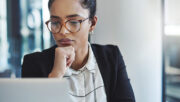 business woman staring seriously at laptop