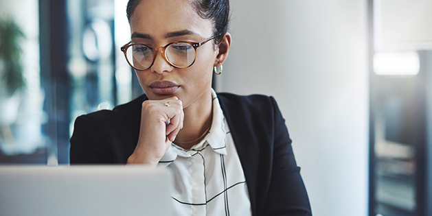 business woman staring seriously at laptop