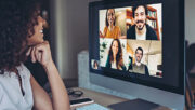 woman in a remote meeting looking at computer screen